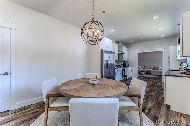 28 Simple Time Dr, Camdenton, MO 65020 - dining space featuring dark wood-style flooring, a chandelier, and recessed lighting