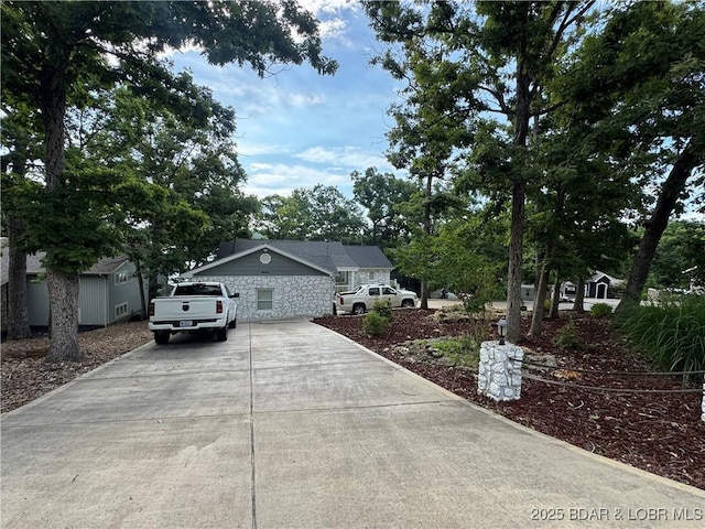 1215 Anemone Rd, Lake Ozark, MO 65049 - view of front of property featuring concrete driveway and stone siding