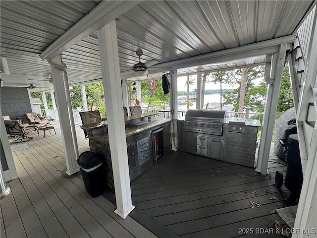 1215 Anemone Rd, Lake Ozark, MO 65049 - wooden deck featuring exterior kitchen, ceiling fan, and a water view