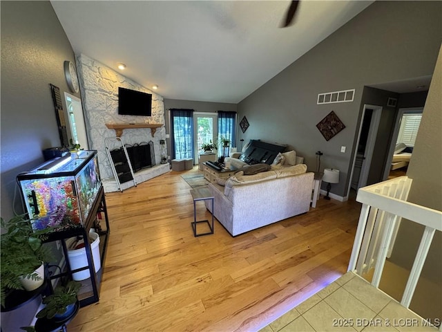 1215 Anemone Rd, Lake Ozark, MO 65049 - living area with a fireplace, light wood-style flooring, and high vaulted ceiling