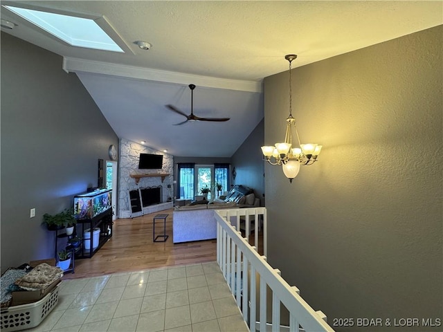 1215 Anemone Rd, Lake Ozark, MO 65049 - living room with tile patterned flooring, a ceiling fan, a fireplace, and a chandelier