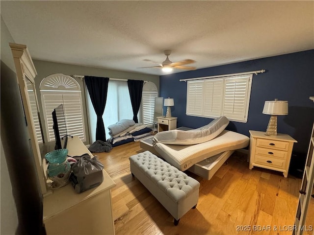 1215 Anemone Rd, Lake Ozark, MO 65049 - bedroom with light wood-type flooring, a ceiling fan, and a textured ceiling
