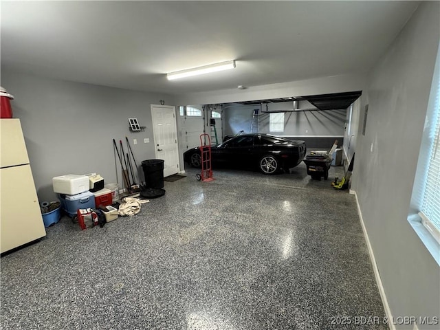 1215 Anemone Rd, Lake Ozark, MO 65049 - garage with freestanding refrigerator and baseboards