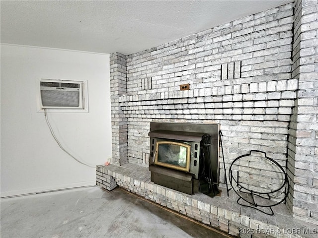 238 Foote Lane Rd, Eldon, MO 65026 - detailed view of concrete flooring, a wall mounted air conditioner, a wood stove, and a textured ceiling