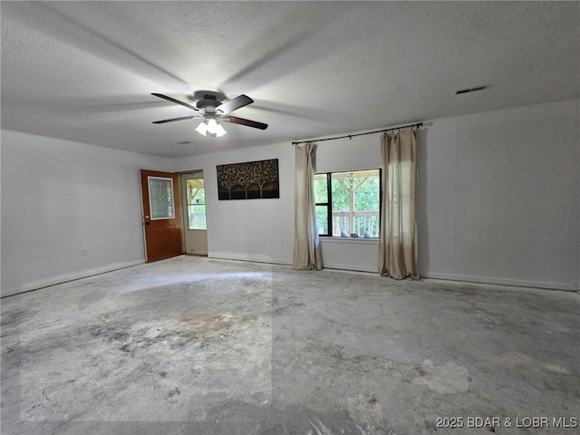 238 Foote Lane Rd, Eldon, MO 65026 - empty room with concrete flooring, plenty of natural light, ceiling fan, and a textured ceiling