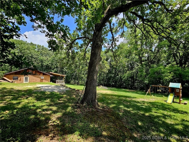 238 Foote Lane Rd, Eldon, MO 65026 - view of grassy yard with a playground and a wooded view