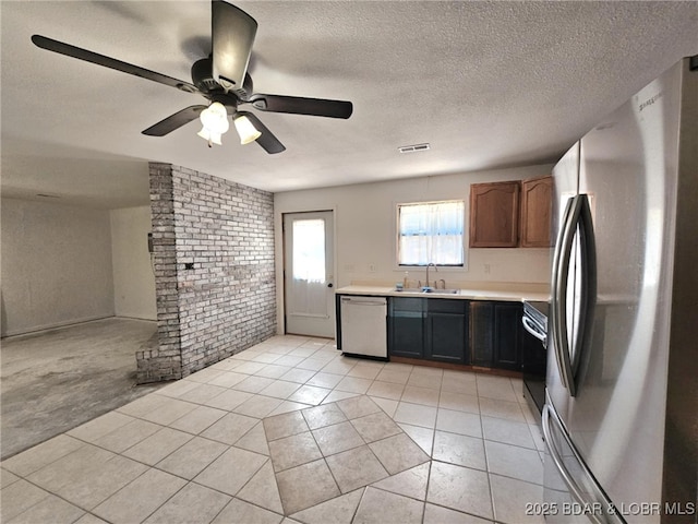 238 Foote Lane Rd, Eldon, MO 65026 - kitchen with stainless steel appliances, light countertops, light tile patterned floors, brick wall, and ceiling fan