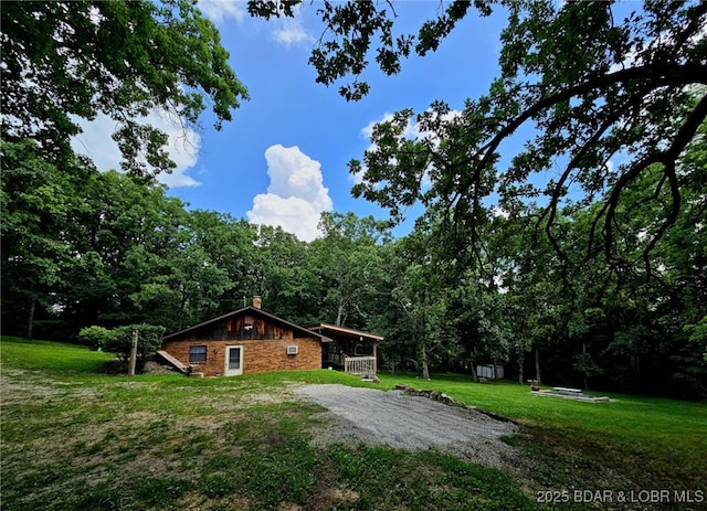238 Foote Lane Rd, Eldon, MO 65026 - view of property exterior featuring a yard, a chimney, and a wooded view