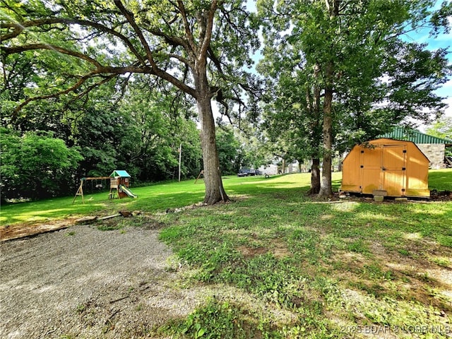 238 Foote Lane Rd, Eldon, MO 65026 - view of grassy yard featuring a storage shed and a playground