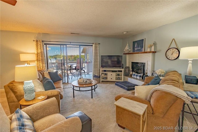 28 Eleven W Ct Unit 2A, Sunrise Beach, MO 65079 - carpeted living room featuring a textured ceiling and a fireplace