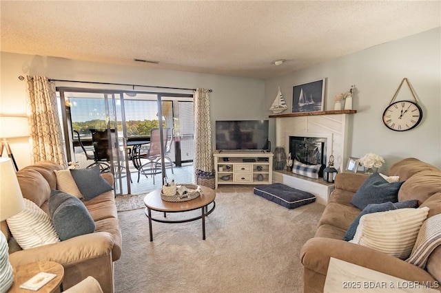 28 Eleven W Ct Unit 2A, Sunrise Beach, MO 65079 - carpeted living room featuring a textured ceiling and a tile fireplace