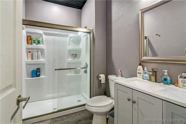 1972 Anderson Hollow Rd, Linn Creek, MO 65052 - bathroom with a shower stall, vanity, wood finished floors, and a textured wall