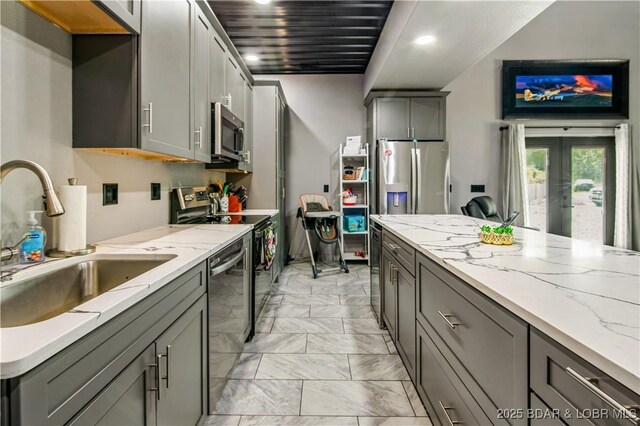 1972 Anderson Hollow Rd, Linn Creek, MO 65052 - kitchen with appliances with stainless steel finishes, light marble finish flooring, gray cabinetry, light stone counters, and recessed lighting