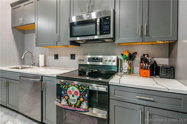 1972 Anderson Hollow Rd, Linn Creek, MO 65052 - kitchen with stainless steel appliances, gray cabinets, and light stone counters