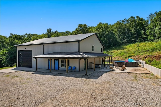 1972 Anderson Hollow Rd, Linn Creek, MO 65052 - rear view of house featuring a hot tub, a metal roof, a porch, and driveway