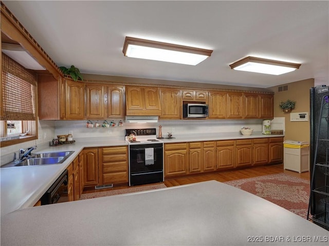 245 Adrian Ln, Climax Springs, MO 65324 - kitchen featuring range with electric stovetop, stainless steel microwave, dishwasher, under cabinet range hood, and light countertops
