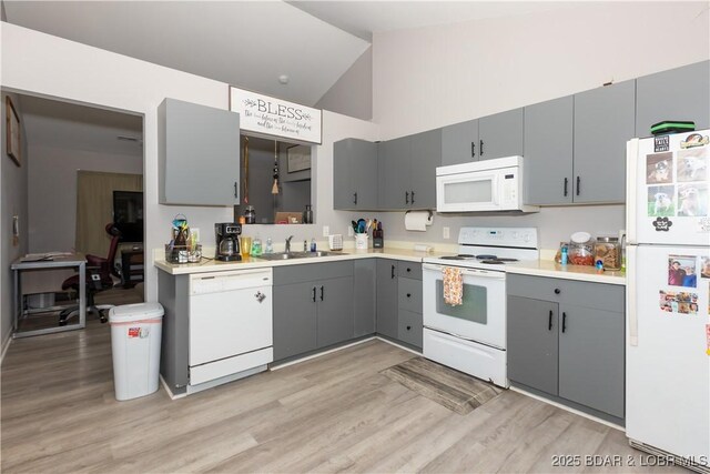 152 Pawnee Rd, Lake Ozark, MO 65049 - kitchen with white appliances, gray cabinets, light wood-style floors, light countertops, and high vaulted ceiling