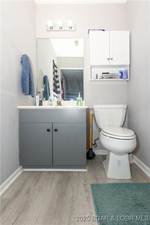 152 Pawnee Rd, Lake Ozark, MO 65049 - bathroom with wood finished floors and vanity
