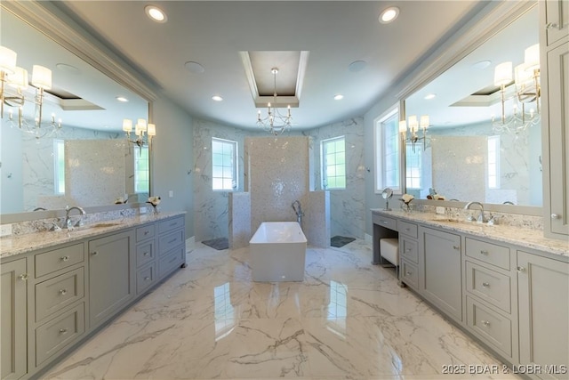 348 Cedar Crest Dr, Lake Ozark, MO 65049 - bathroom with a chandelier, a marble finish shower, a freestanding bath, two vanities, and recessed lighting