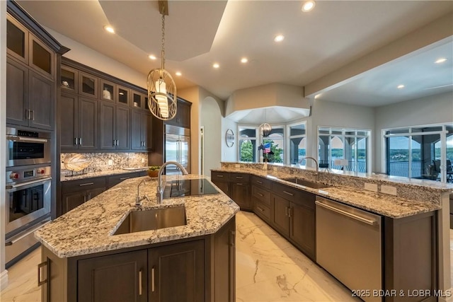 348 Cedar Crest Dr, Lake Ozark, MO 65049 - kitchen featuring appliances with stainless steel finishes, a warming drawer, recessed lighting, a kitchen island with sink, and dark brown cabinetry