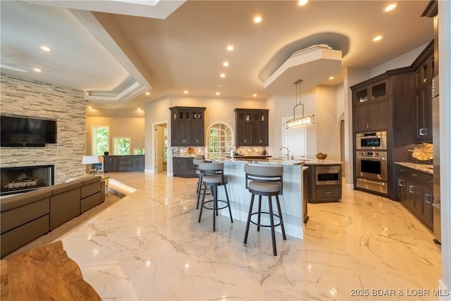 348 Cedar Crest Dr, Lake Ozark, MO 65049 - kitchen featuring a kitchen bar, a warming drawer, a large island, open floor plan, and recessed lighting