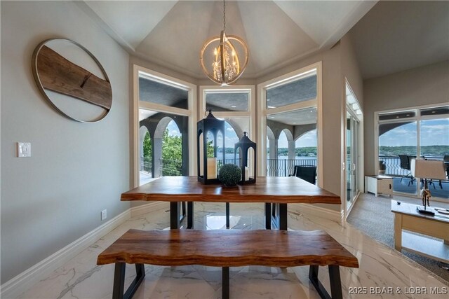 348 Cedar Crest Dr, Lake Ozark, MO 65049 - dining space featuring light marble finish floors, a chandelier, plenty of natural light, and vaulted ceiling