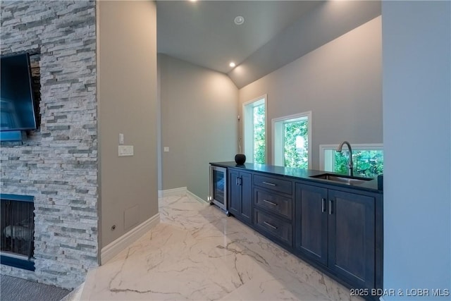 348 Cedar Crest Dr, Lake Ozark, MO 65049 - bathroom with beverage cooler, marble finish floors, a stone fireplace, vaulted ceiling, and recessed lighting