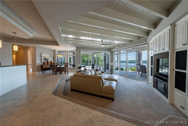 348 Cedar Crest Dr, Lake Ozark, MO 65049 - living room featuring healthy amount of natural light, beamed ceiling, a ceiling fan, and light tile patterned floors
