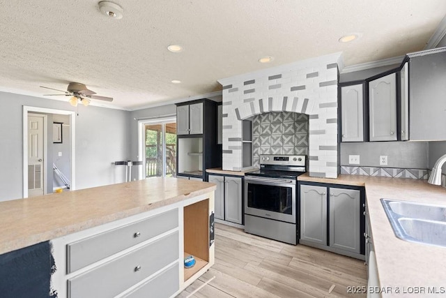 1123 Woodland Dr, Eldon, MO 65026 - kitchen featuring stainless steel electric stove, ornamental molding, light countertops, backsplash, and a ceiling fan
