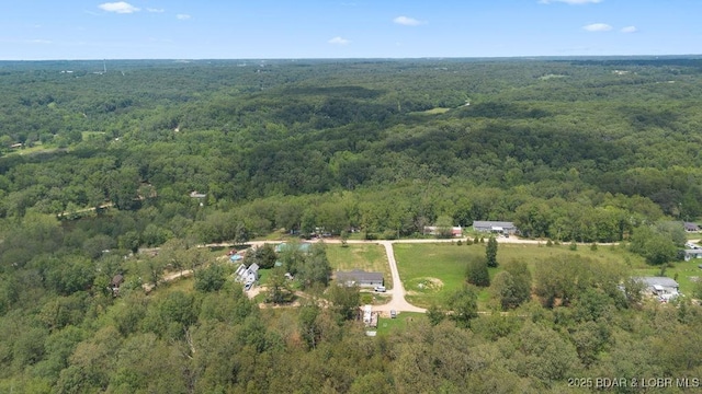 1123 Woodland Dr, Eldon, MO 65026 - aerial view of property and surrounding area with a heavily wooded area