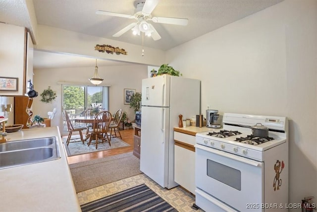 1150 Georgene Rd, Camdenton, MO 65020 - kitchen featuring white appliances, light countertops, a ceiling fan, lofted ceiling, and pendant lighting