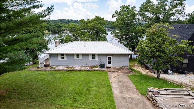 57 Ke Jo Point Rd, Gravois Mills, MO 65037 - rear view of property featuring a chimney, a yard, a metal roof, and a deck with water view