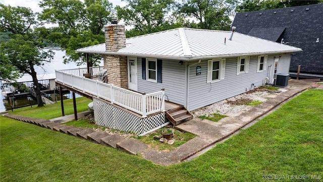 57 Ke Jo Point Rd, Gravois Mills, MO 65037 - rear view of property with a chimney, a yard, a water view, and a metal roof