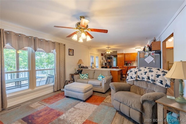 57 Ke Jo Point Rd, Gravois Mills, MO 65037 - living room featuring ceiling fan, light wood finished floors, and ornamental molding