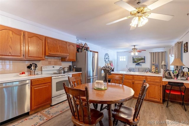 57 Ke Jo Point Rd, Gravois Mills, MO 65037 - kitchen with appliances with stainless steel finishes, light wood finished floors, ceiling fan, and light countertops