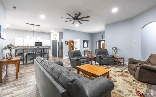 432 Cornett Branch Rd, Four Seasons, MO 65049 - living area featuring arched walkways, a ceiling fan, light wood-style flooring, and recessed lighting