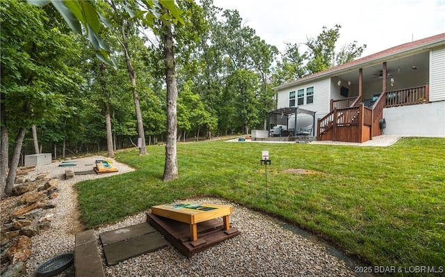 432 Cornett Branch Rd, Four Seasons, MO 65049 - view of grassy yard featuring a ceiling fan, a vegetable garden, a patio, and stairway