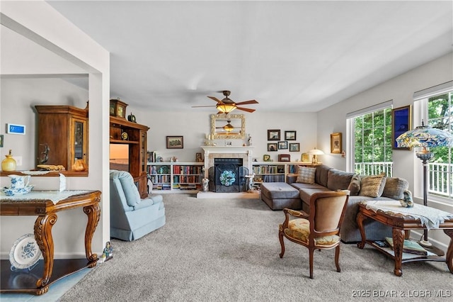 1008 Beacon Ridge Dr, Lake Ozark, MO 65049 - living area featuring ceiling fan, carpet floors, and a fireplace with raised hearth