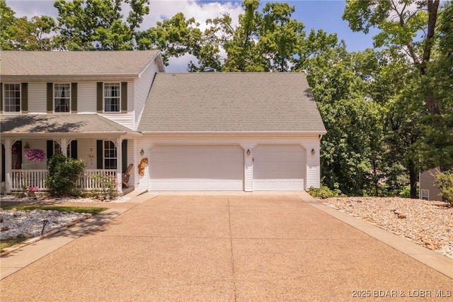 1008 Beacon Ridge Dr, Lake Ozark, MO 65049 - colonial-style house featuring covered porch, a garage, and concrete driveway
