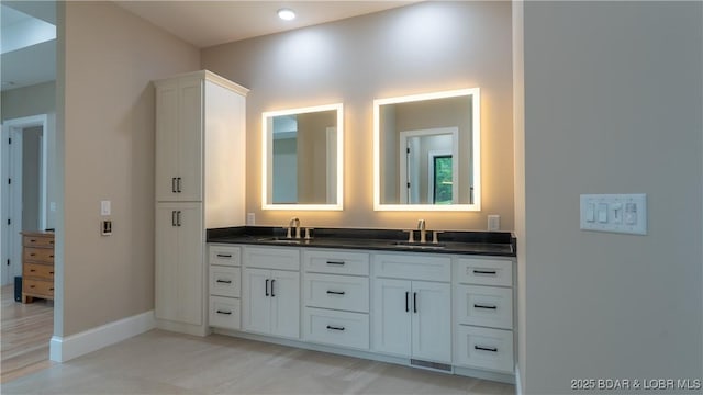 1254 Darwin Dr, Osage Beach, MO 65065 - full bathroom with double vanity and baseboards