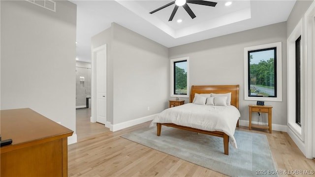 1254 Darwin Dr, Osage Beach, MO 65065 - bedroom featuring a tray ceiling, light wood finished floors, recessed lighting, and a ceiling fan