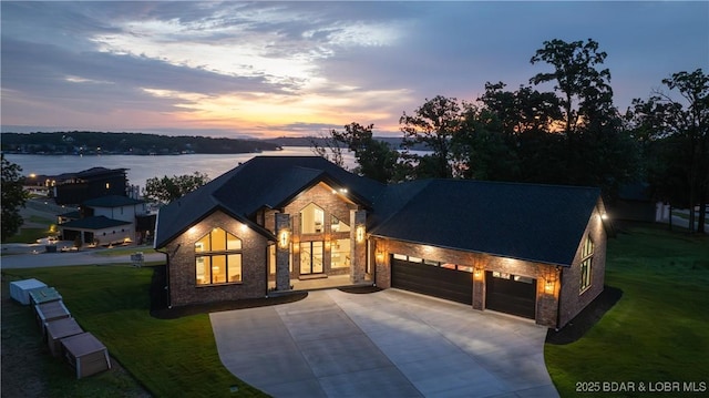 1254 Darwin Dr, Osage Beach, MO 65065 - view of front of property with concrete driveway, a garage, a lawn, and stone siding