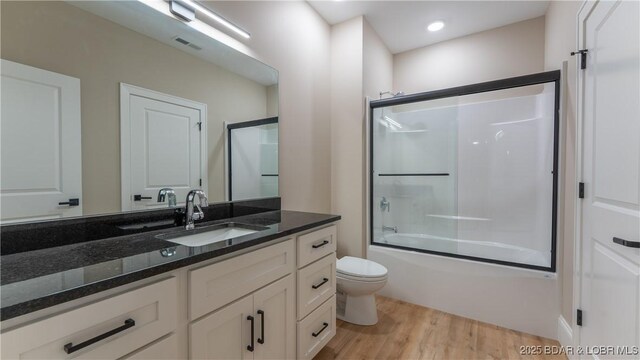 1254 Darwin Dr, Osage Beach, MO 65065 - bathroom with vanity, wood finished floors, combined bath / shower with glass door, and recessed lighting