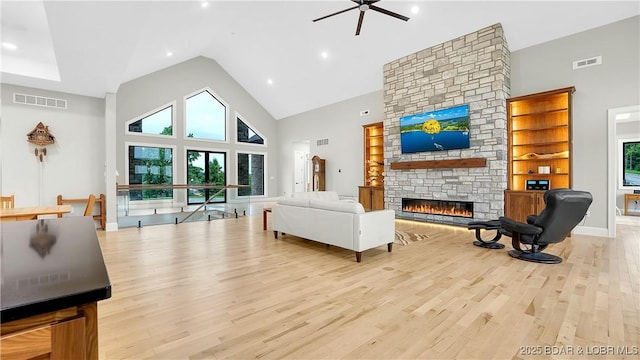1254 Darwin Dr, Osage Beach, MO 65065 - living room featuring high vaulted ceiling, a fireplace, a ceiling fan, light wood-style flooring, and recessed lighting