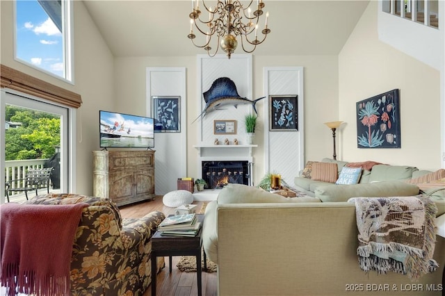 541 Elbow Cay Dr, Osage Beach, MO 65065 - living room with wood finished floors, a chandelier, and a premium fireplace
