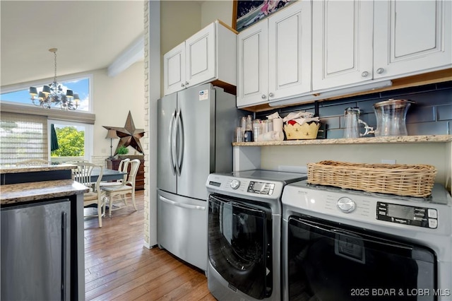541 Elbow Cay Dr, Osage Beach, MO 65065 - kitchen with fridge, freestanding refrigerator, a chandelier, light wood finished floors, and white cabinetry