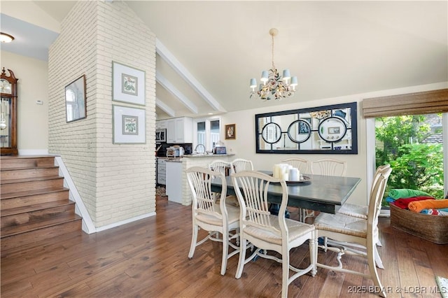 541 Elbow Cay Dr, Osage Beach, MO 65065 - dining space with lofted ceiling, a chandelier, wood finished floors, brick wall, and stairway