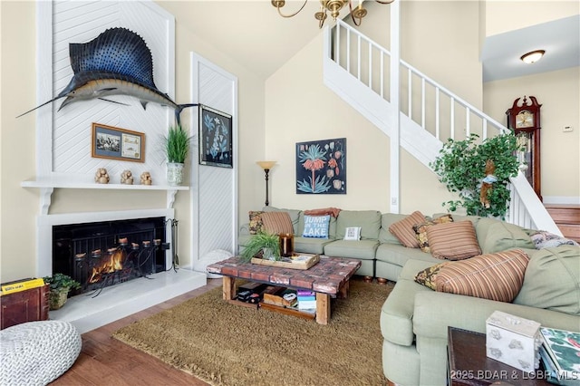 541 Elbow Cay Dr, Osage Beach, MO 65065 - living room featuring wood finished floors, stairs, a fireplace, and lofted ceiling