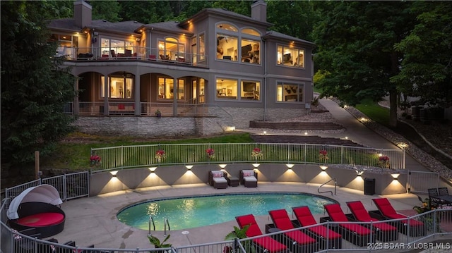 1453 Grand View Dr, Porto Cima, MO 65079 - rear view of house with a chimney, a balcony, a patio area, and stucco siding