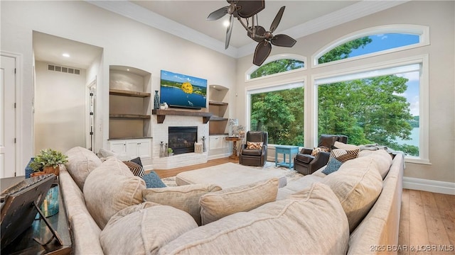 1453 Grand View Dr, Porto Cima, MO 65079 - living area featuring ceiling fan, hardwood / wood-style floors, a fireplace, ornamental molding, and recessed lighting